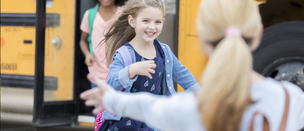 Girl getting off school bus
